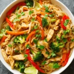 Quick rice noodle stir fry with chicken, vegetables, and herbs