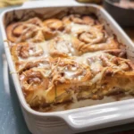 Cinnamon Roll Casserole – Easy Christmas Morning Breakfast & Brunch Idea 4 Golden baked cinnamon roll casserole fresh from oven with sweet glaze drizzled on top