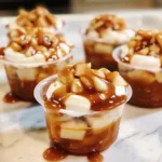 Caramel Apple Dessert Cups: Irresistible Fall-Inspired Treats 6 Caramel apple dessert cups with caramel drizzle and cinnamon topping