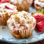 Strawberry Crumb Cake Muffins: A Sweet Delight for Every Morning 6 Halved Strawberry Crumb Cake Muffin showing soft and moist interior with fresh strawberries.