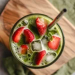 Strawberry Matcha Latte in a glass, iced green tea drink with strawberry syrup