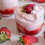 strawberry mousse in a glass with whipped cream