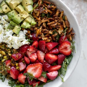 Fresh Strawberry Salad with greens, strawberries, nuts, and feta